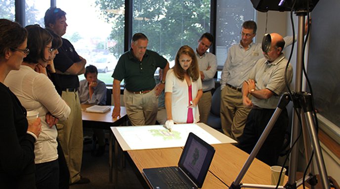 Nicole Minni, GIS Specialist demonstrates how to use the Wii Table.