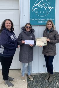 Kym Kelly and Nicole Minni present a check to Suzanne Thurman of the Marine Education, Research & Rehabilitation Institute (MERR) on behalf of the GIS Day Committee..